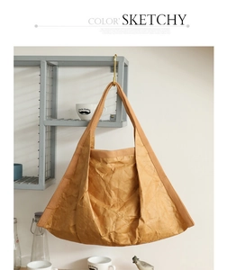 Detailed view of the vintage wrinkled texture and wide fabric strap on a large tote bag