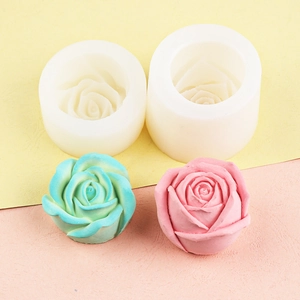 Detail showing white silicone rose molds with 3D pink and teal floral candle samples