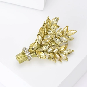Detail of golden wheat brooch with yellow marquise rhinestones and white accents