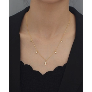 Close-up of gold star pendant necklace with cubic zirconia on model neck