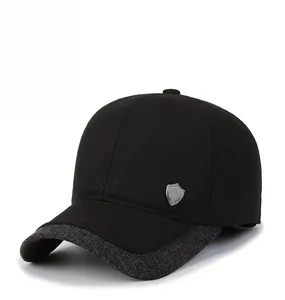 Detailed view of winter baseball cap with grey tweed brim and silver shield logo