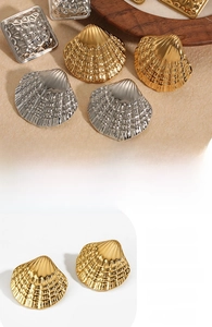 Detailed view of vintage pleated shell earrings with a metallic hammered texture finish