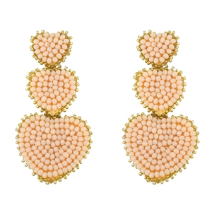 Detailed close-up of three-tier peach pink seed bead heart earrings with gold trim