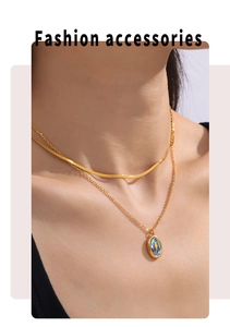 Double-layered gold titanium necklace with shell star pendant worn by model closeup