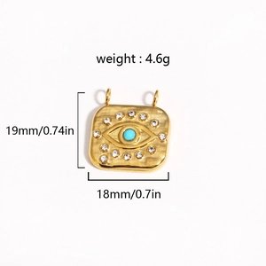 Macro view of gold sunburst pendant with turquoise eye and weight dimensions