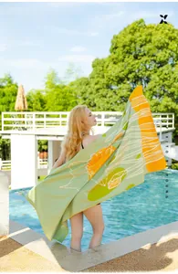 Microfiber sand-free beach towel featuring floral patterns and vibrant sunburst design