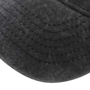 Macro detail of the six-row stitching on the vintage washed cotton baseball cap brim