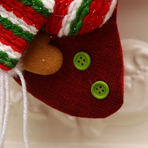 Classic red burlap Christmas stocking with green knit trim and festive button detail