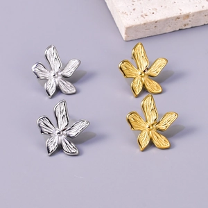 Detailed macro of vintage 18k gold and silver plated floral earrings in 2 pairs set