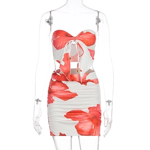 Detail of red floral tube top with large bow tie and ruched bodycon skirt set