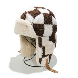 Winter checkered plush trapper hat with warm faux lamb wool and ear flaps on stand