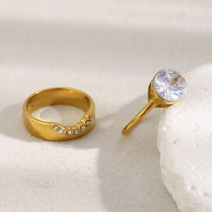 Detail of 18K gold plated stainless steel ring set with large zircon and curved micro-pave band