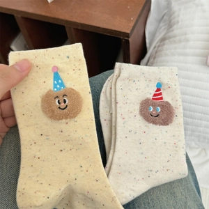 Detailed close-up of cartoon bear embroidery on cute speckled cotton crew socks
