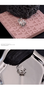 Detailed view of punk style silver heart ring on creative texture background