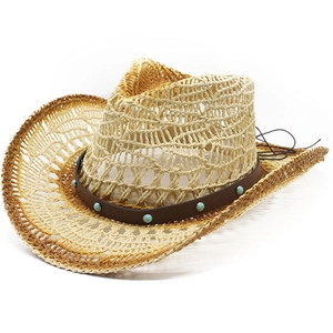 Detail of hollow-out straw cowboy hat with turquoise rivets and natural woven texture