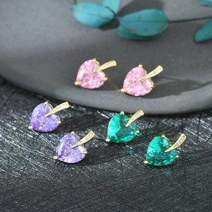 Detailed close-up of heart-shaped zircon earrings in pink, purple, and green colors