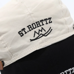 Detailed view of the ST. RORTTZ embroidery and stitching on the two-tone canvas cap
