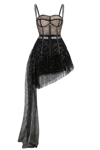 Detail of black mesh sequin mini dress featuring an asymmetric tulle train and corset bodice