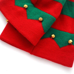 Detailed macro view of red and green knitted Christmas fabric with golden bells