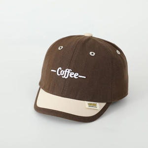 Detail view of cotton baseball cap showing coffee embroidery and contrast stitching