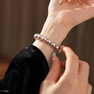 Detail of lavender pearl beaded bracelet worn on wrist with elegant French vintage style