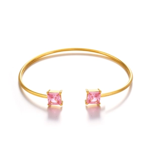 Minimalist gold cuff bracelet with square pink zircon stones in a sleek open design