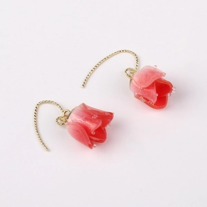 Detailed view of pink gradient tulip earrings with golden hooks and bead accents