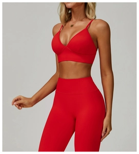 Detail of red V-neck seamless sports bra and high-waisted leggings set for fitness