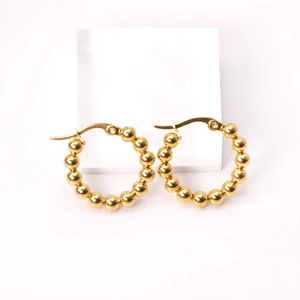Detailed view of 18K gold stainless steel hoop earrings with unique beaded ball design