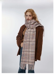 Detail of soft plaid scarf with fringe edge, close-up of thick colorful checkered fabric