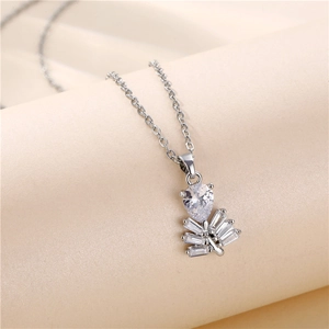 Elegant silver leaf necklace with teardrop and rectangular crystal pendant on fabric