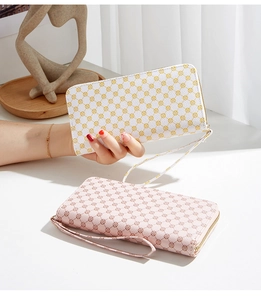 Detailed view of floral pattern long zip wallets in white and pink with wrist straps