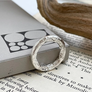 Minimalist 925 sterling silver ring with irregular hammered texture on vintage background