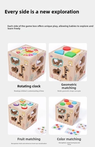 Detail view of wooden activity cube showing clock, shape sorting and fruit matching panels