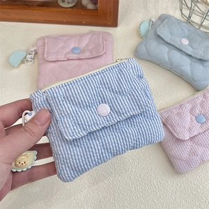 Detail of quilted cotton coin purses with snap buttons, zippers and cute bear charms