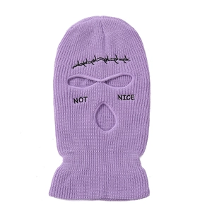 Detail of purple knitted balaclava mask with NOT NICE text and wire fence embroidery