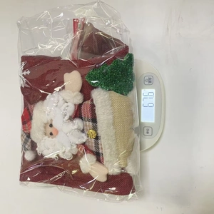 Detailed view of handmade Christmas stockings with Santa Claus doll and plaid linen patterns