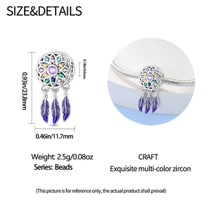 Detailed view of dreamcatcher charm with colorful zircons and purple enamel feathers