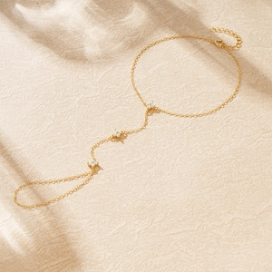 Detailed view of a gold S925 silver slave bracelet with sparkling zircon flower charms
