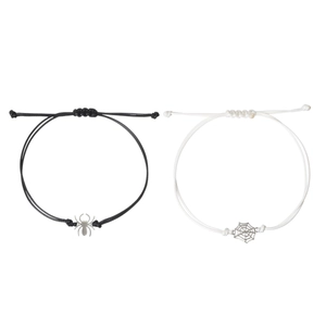 Detail of adjustable couple bracelets with spider and web charms on woven rope