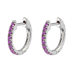 Detail view of silver hoop earrings featuring sparkling purple zircon stones on a white background