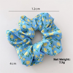 Detail showing 12cm light blue floral hair scrunchie dimensions and 7.3g net weight