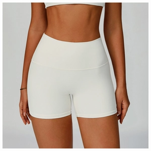 Detailed close-up of white ribbed high-waisted fitness shorts with seamless texture