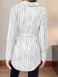 Women's white lapel shirt dress with black pinstripes and matching belt, back view