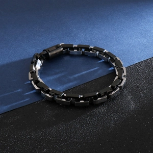 Detail of punk style men's stainless steel bracelet with black and silver interlocking links