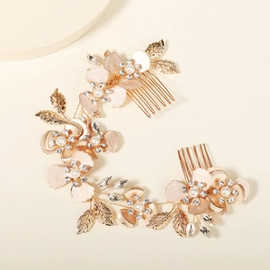 Detail view of bridal hair comb set with pink enamel flowers, pearls and golden leaves