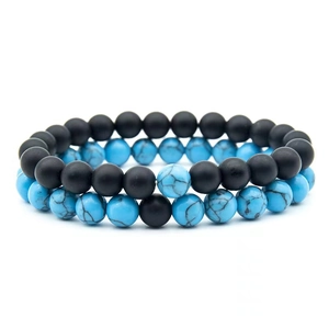 Detailed view of 8mm matte black lava stone and blue turquoise beaded couple bracelets set