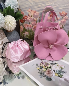 Detail of pink floral petal tote bag with silk drawstring liner and matte PU texture