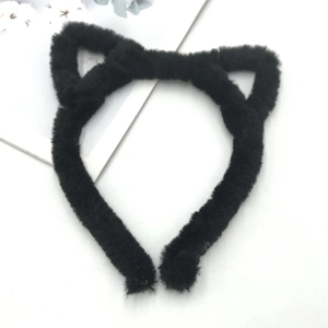 Detailed view of plush black cat ear headband with soft faux fur texture for cosplay