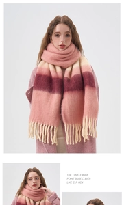 Detail shot of soft striped acrylic scarf featuring pink gradient and tassel edges